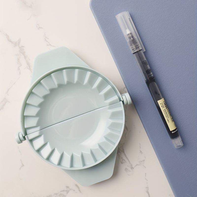 alt="dumpling maker press light green kitchen tool"