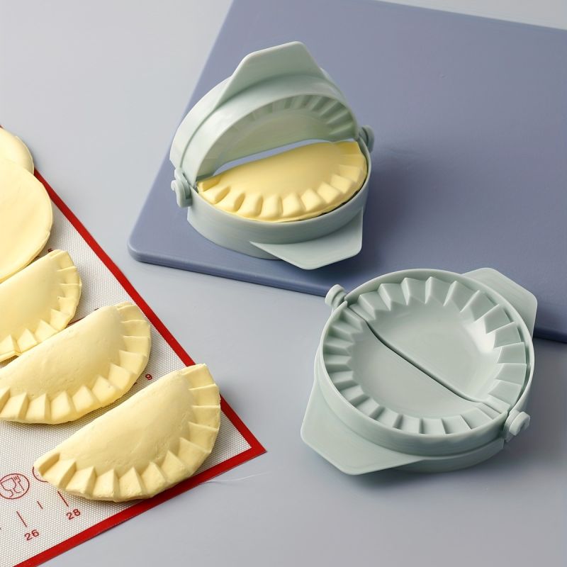 alt="dumpling maker press light green kitchen tool"